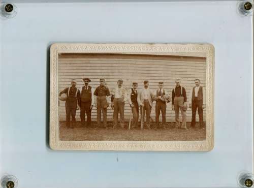 Early Base Ball Team in Front of Wall with Gloves ad Bats